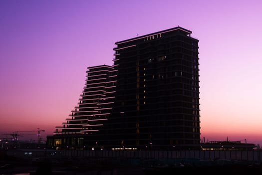 Silhouette of the Belgrade Waterfront buildings on dramatic pink sky background.