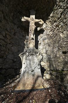 A stone cross in a cave. An old stone cross for pilgrims.