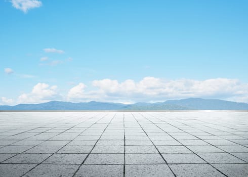 Empty floor in front of blue sky .