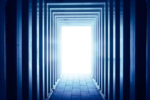 Line-shaped corridors leading to unknown bright exit door .