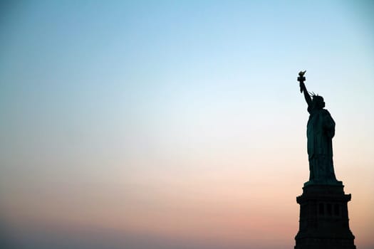 Sunset behind Statue of Liberty