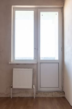Exit to the balcony in the interior of an unrepaired room