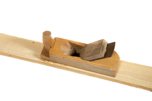 Old wooden hand planer or Carpenter Tool on wood plank isolated white background