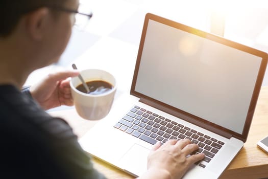 Coffee in businessman hand with Laptop .