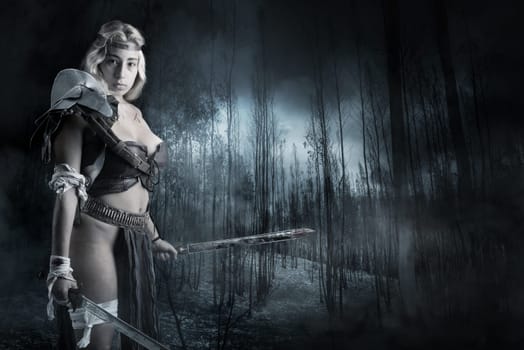 Ancient woman warrior or Gladiator posing outdoors with sword and shield