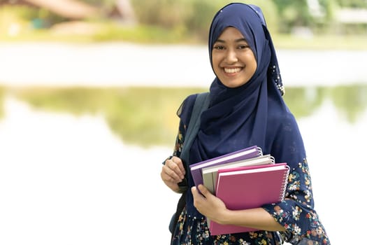 Portrait of good-looking Happy young teenager Muslim islamic asian university girl
