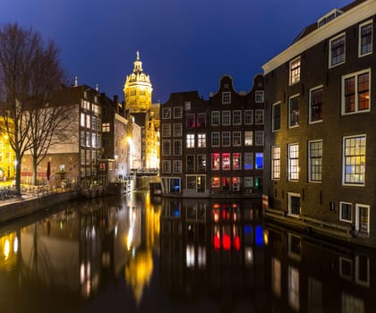 Amsterdam Canals and Saint Nicholas church sunset Netherlands