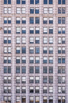 Urban abstract - window facade of business center office building with reflections and colours. Chicago IL USA.