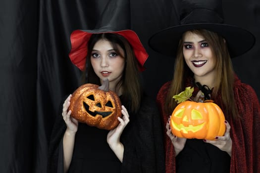 Two teenages and young adult girl women in Halloween costume for Halloween party background