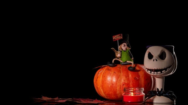 Halloween still life with pumpkin, autumn leaves, candle and witch on a black background. Halloween background