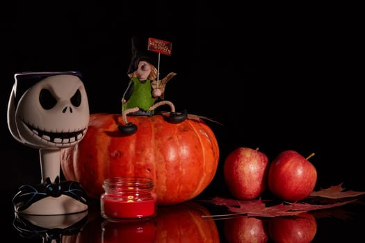 Halloween still life with pumpkin, autumn leaves, candle and witch on a black background. Halloween background