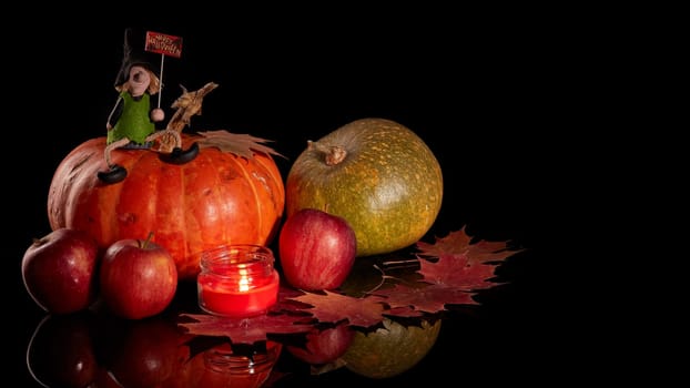 Halloween still life with pumpkin, autumn leaves, candle and witch on a black background. Halloween background
