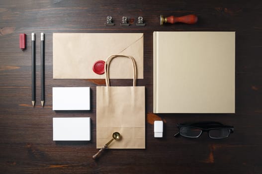 Blank kraft stationery set on wooden background. Branding identity mock-up. Flat lay.