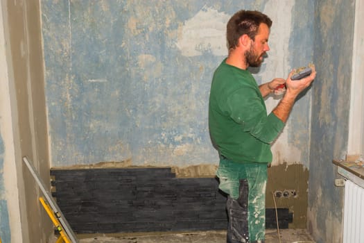 Workers install ceramic retro effect brick tiles