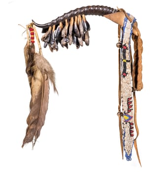 Dance rattle of the North American Indian horn with deer hooves and feathers isolated on white