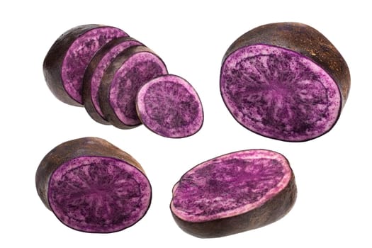 Purple potato (Solanum tuberosum), halved and partially sliced tubers, isolated