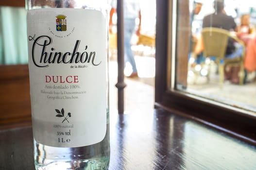 Chinchon, Spain – Jun 2017: Anisette bottle served at main square cafe of Chinchon, near Madrid