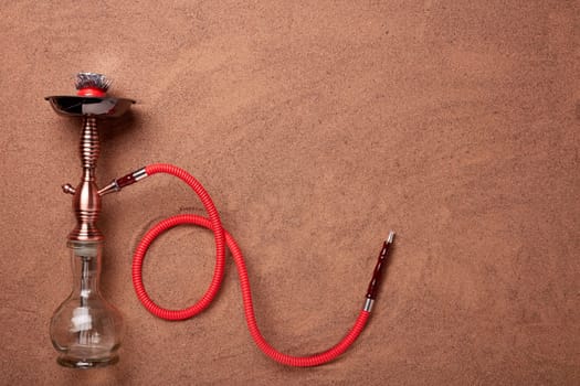 Turkish hookah (shisha) on a sand background.