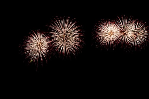 abstract Fireworks light up the dark sky background
