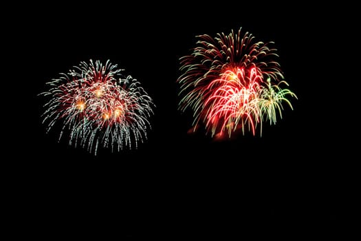 abstract Fireworks light up the dark sky background