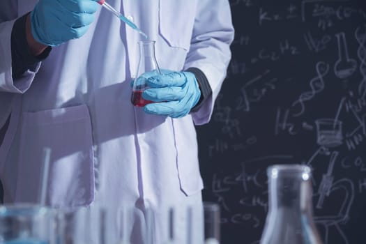 Researcher with glass laboratory chemical test tubes with liquid for analytical , medical, pharmaceutical and scientific research concept.