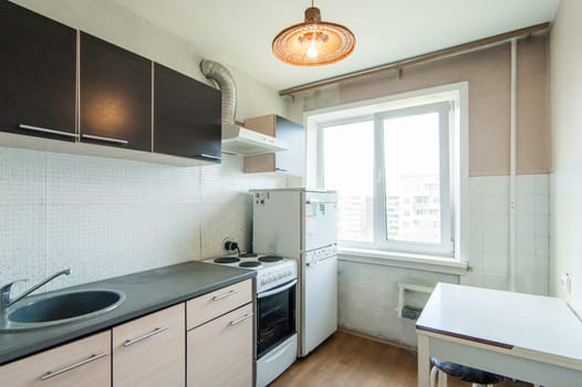 Russia, Moscow- May 16, 2019: interior room apartment. standard repair decoration in hostel. kitchen and dining room