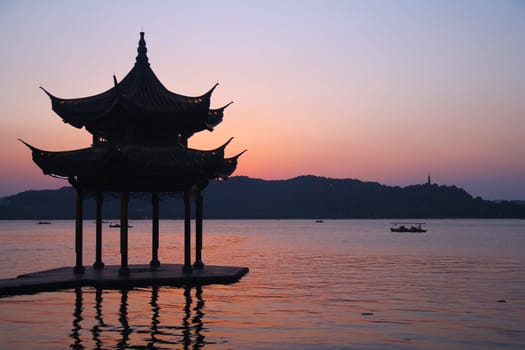 Sunset with a pagoda on the beautiful Hangzhou lake in China