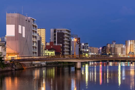 Fukuoka old town along naka river at Nakasukawabata sunset twilight. This area is favorite for tourist for Fukuoka Yatai, street Food stall,  for hangout at night.