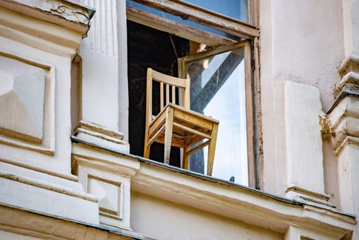 Old wooden chair in window of house in Vyborg. Travel in Russia.