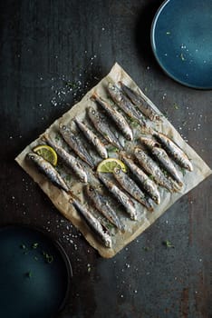 Grilled sardines with lemon and herbs close up. Healthy vegetarian fish meal