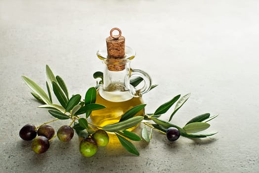 Healthy olive oil bottle with fresh olives ingredients close up. Healthy concept