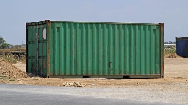 One Green Cargo Shipping Container at Field