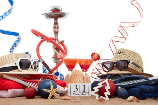 Beach accessories, seashells, sand, two glasses of cocktail, hookah (shisha) and christmas ornaments on white background. New Year. Winter vacation in warm countries, beach holiday