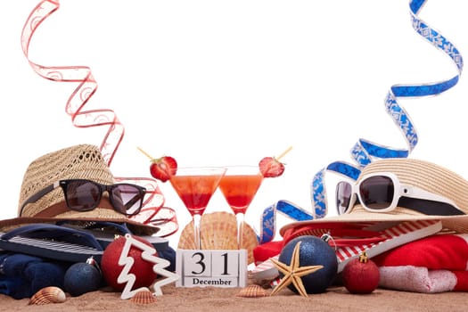 Beach accessories (flip flops, straw hats, seashells, sand, sunglasses), two glasses of cocktail, christmas ornaments on white background. New Year. Winter vacation in warm countries, beach holiday