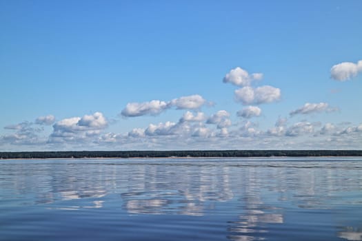 Calm  scene of beautiful sky with cumulus clouds reflection on the sea, hdr