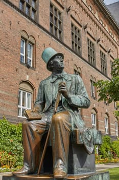COPENHAGEN, DENMARK - JUNE 28, 2017: Hans Christian Andersen statue by Henry Luckow-Nielsen in front of Tivoli Aumusement Park in Copenhagen, Denmark.