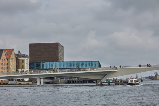 COPENHAGEN, DENMARK - MAY 25, 2017: Modern building of the New Royal Playhouse Theater in historic city center facing famous Copenhagen waterfront, Nyhavn, Denmark.