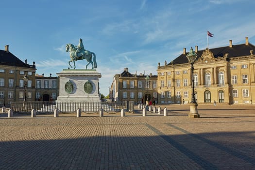 COPENHAGEN, DENMARK - MAY 25, 2017: Amalienborg is the residence of the Danish Royal Family. The palace is octagonal with a statue of King Frederik V in centre.