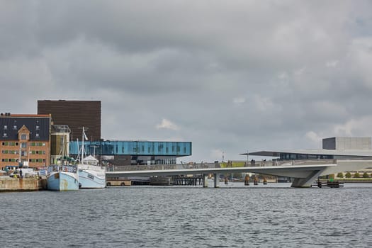 COPENHAGEN, DENMARK - MAY 25, 2017: Modern building of the New Royal Playhouse Theater in historic city center facing famous Copenhagen waterfront, Nyhavn, Denmark.