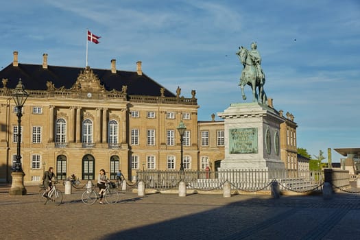 COPENHAGEN, DENMARK - MAY 25, 2017: Amalienborg is the residence of the Danish Royal Family. The palace is octagonal with a statue of King Frederik V in centre.