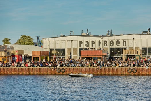 COPENHAGEN, DENMARK - MAY 25, 2017: Street food market Papiroen on the paper island in Copenhagen with a lot of people on the quay.