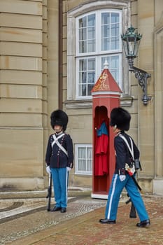 COPENHAGEN, DENMARK - SEPTEMBER 16, 2017: Royal Guards during the ceremony of changing the guards on the square at Amalienborg Castle, Copenhagen, Denmark