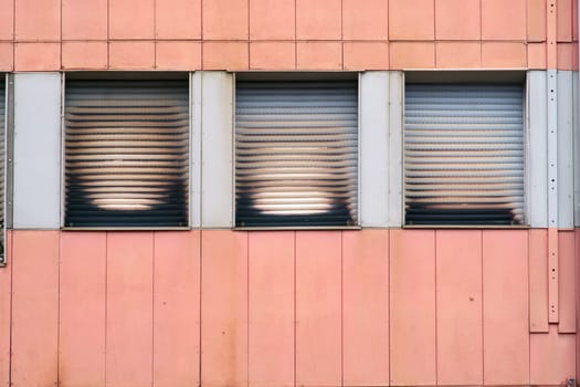 Smoke traces and traces of smoke on the lowered blinds of an apartment after a fire.....