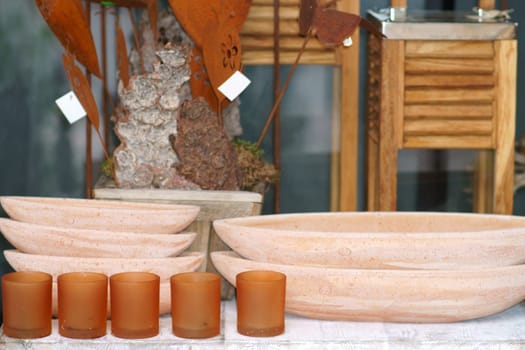 Various clay bowls or bowls made of terracotta on a sales stall with artisanal objects.