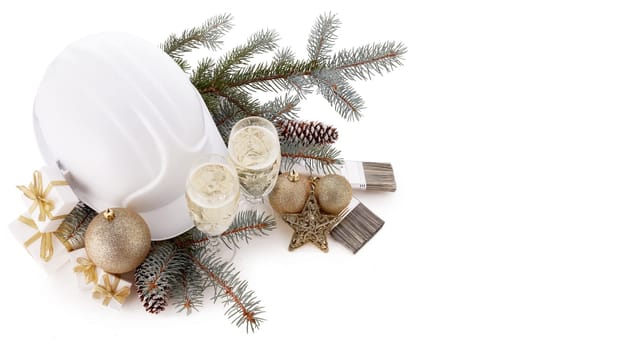 Construction hard hat, fir branches, two glasses with champagne, gift boxes, Christmas ornament isolated on white background. New Year and Christmas construction background, Top view