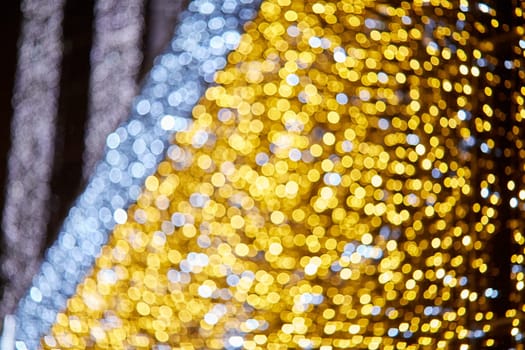 Festive background with LED lights garland. Christmas and New Year background. Blurred bokeh from the lights of a garland.