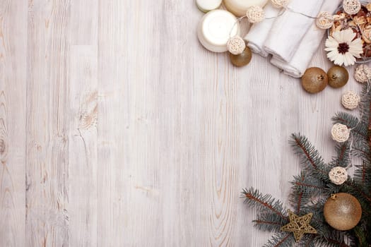 Spa still life with cosmetic creams, towel and Christmas ornaments on light wooden background. Top view with copy space. New Year and Christmas Healthy lifestyle, body care, Spa treatment