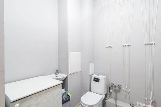 Russia, Moscow- May 20, 2019: interior room apartment. standard repair decoration in hostel. modern bathroom, sink, decoration elements, toilet.