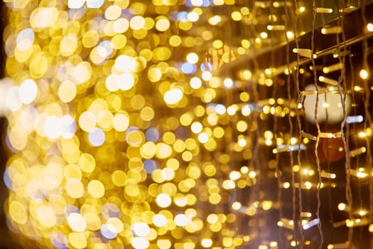 Festive background with LED lights garland. Christmas and New Year background. Blurred bokeh from the lights of a garland.