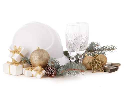Construction hard hat, fir tree branches, two empty glasses for champagne, gift boxes and Christmas ornament isolated on a white background. New Year and Christmas construction background